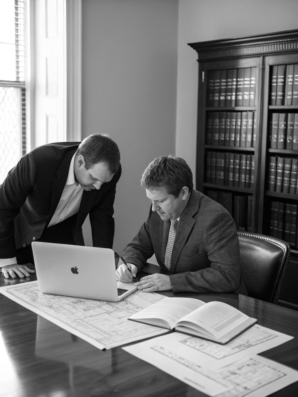 Executive consultation in a high-contrast monochrome setting